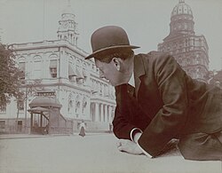 Reclining man looming over New York City subway station LCCN2017645506